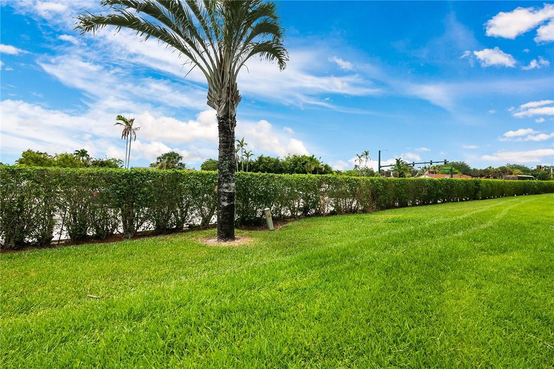 9085 Southwest 20th Street, Unit D Boca Raton, FL 33428 - Photo 21 of 25 a view of a grassy field with an trees