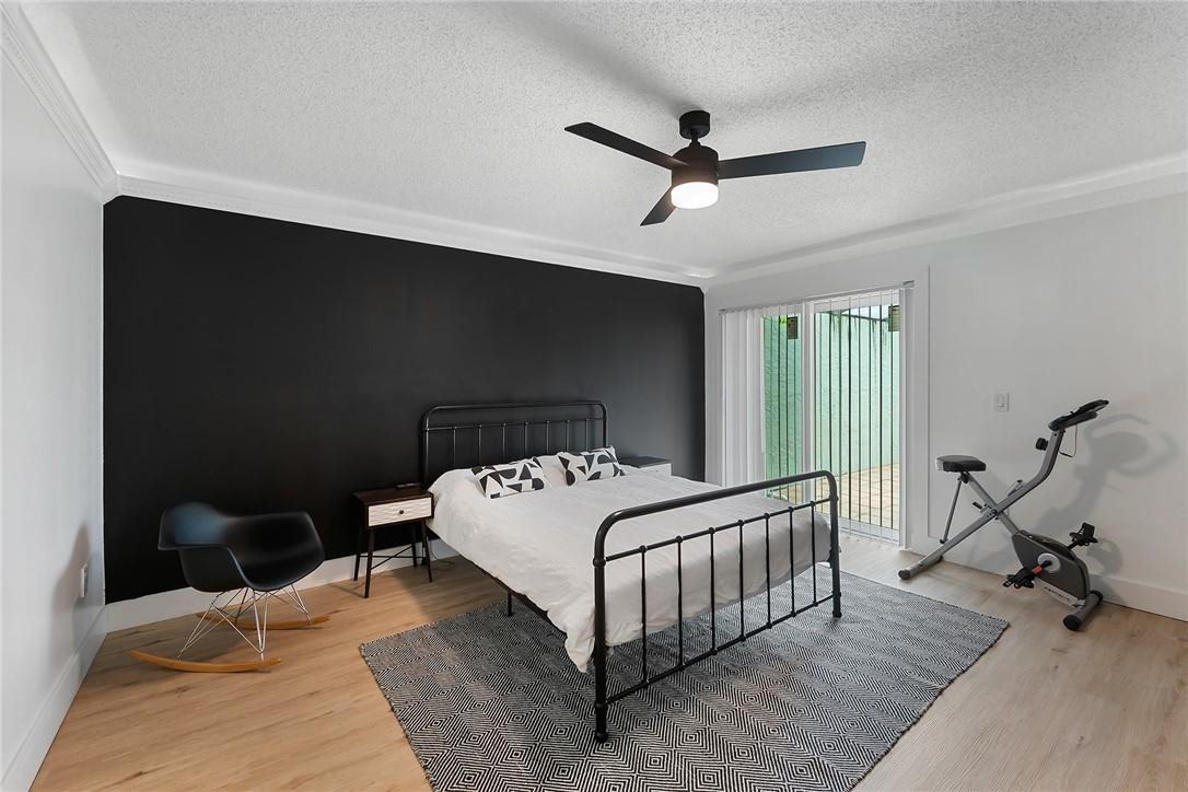9085 Southwest 20th Street, Unit D Boca Raton, FL 33428 - Photo 10 of 25 a bedroom with a bed and a ceiling fan