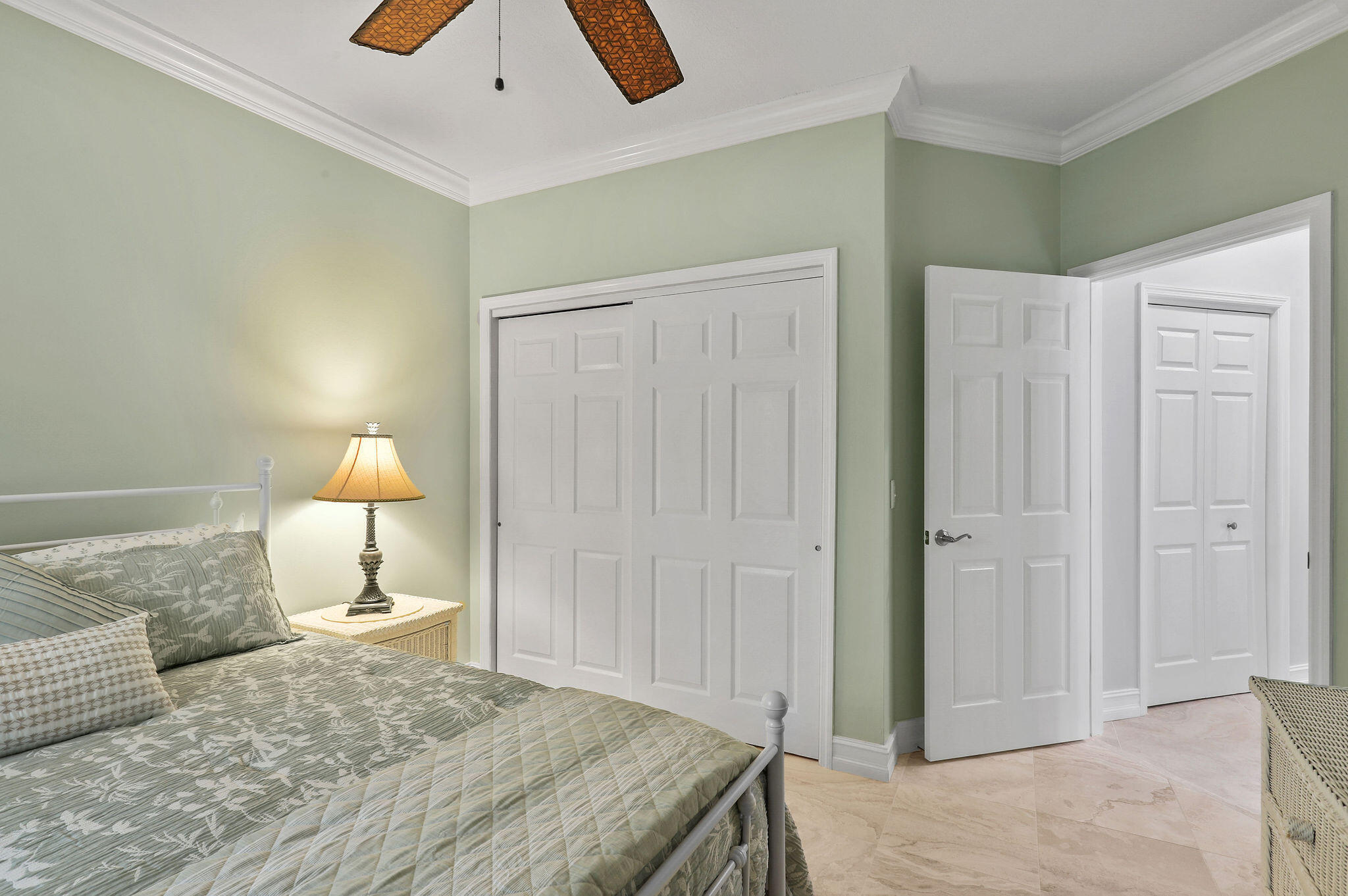 2056 Windward Way Jupiter, FL 33477 - Photo 23 of 58 a bedroom with a bed and a lamp