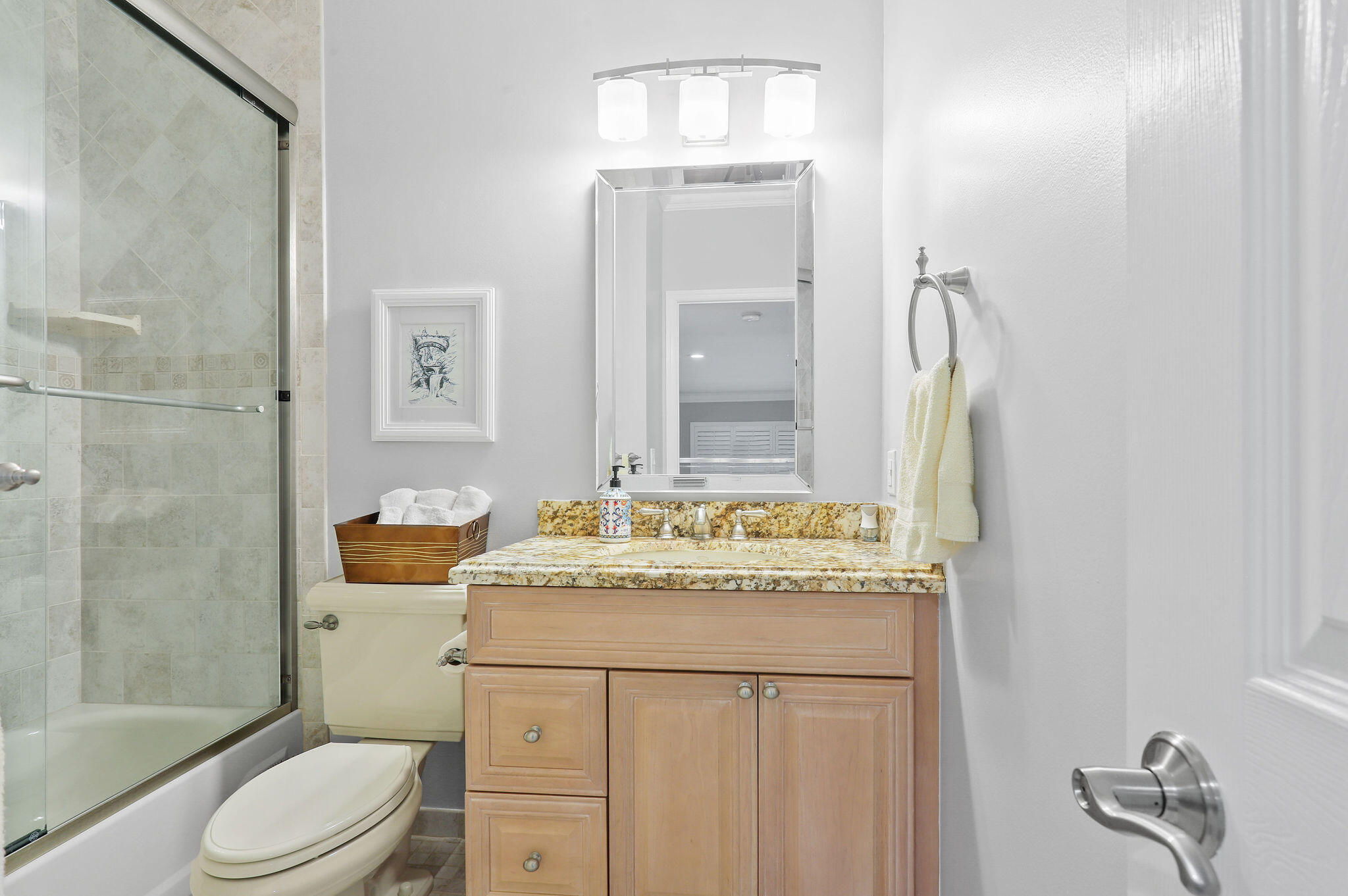 2056 Windward Way Jupiter, FL 33477 - Photo 29 of 58 a bathroom with a granite countertop sink toilet a mirror and shower