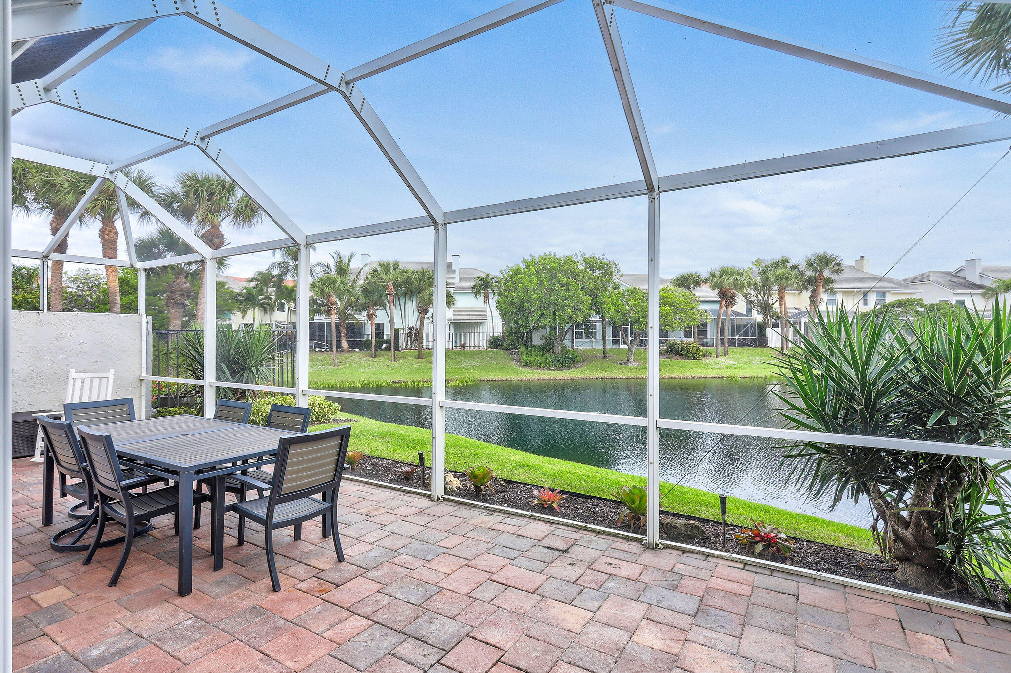 2056 Windward Way Jupiter, FL 33477 - Photo 30 of 58 a view of a chair and tables in the patio