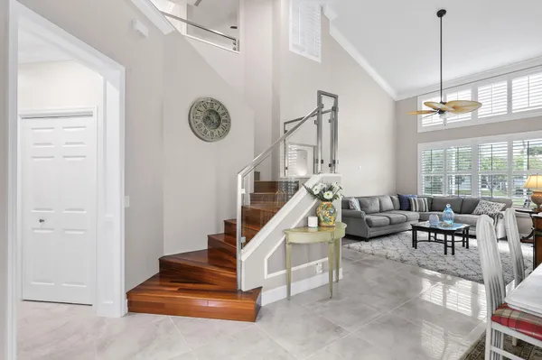 a living room with furniture a chandelier and a window