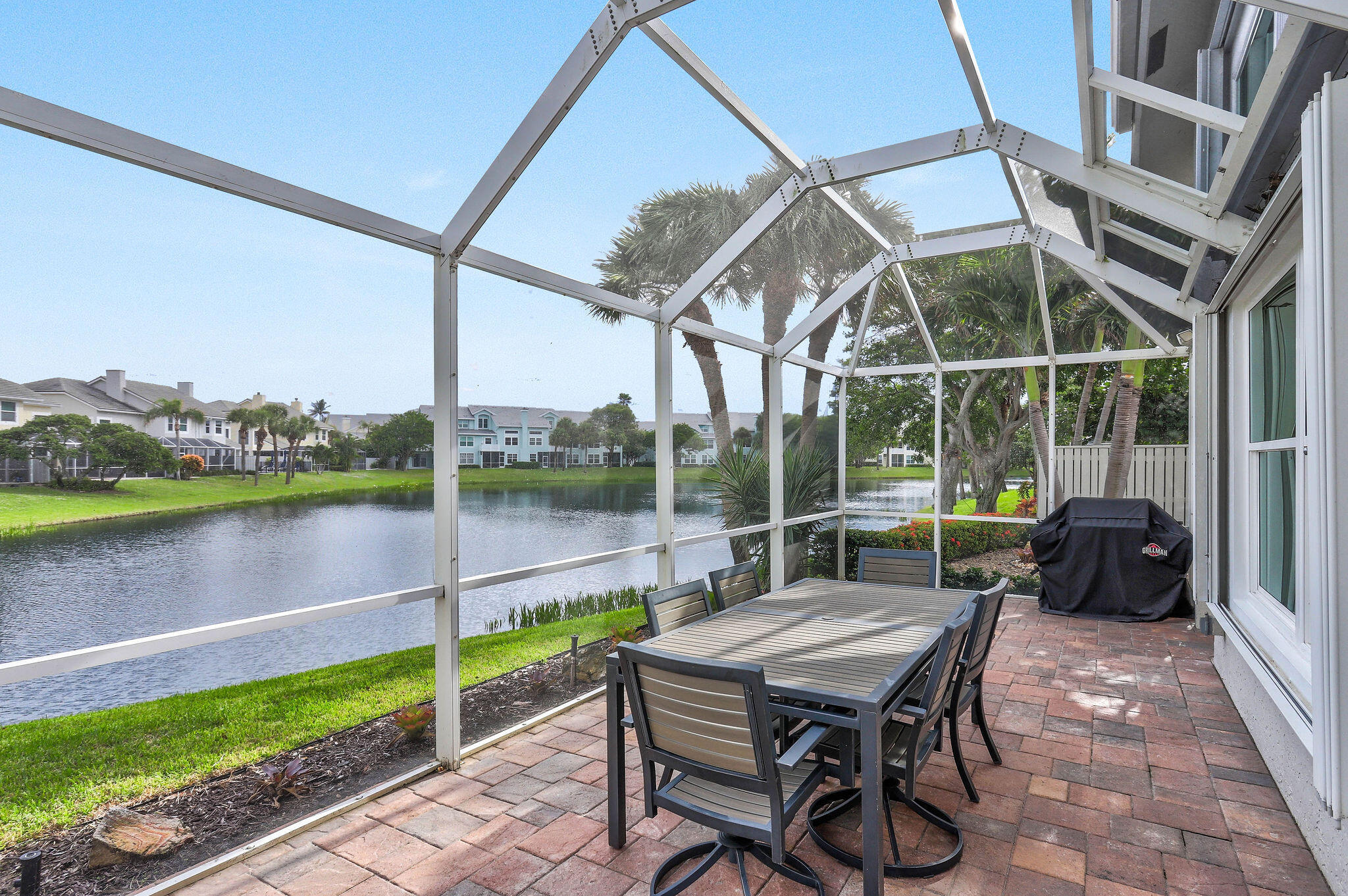 2056 Windward Way Jupiter, FL 33477 - Photo 33 of 58 a roof deck with table and chairs and potted plants