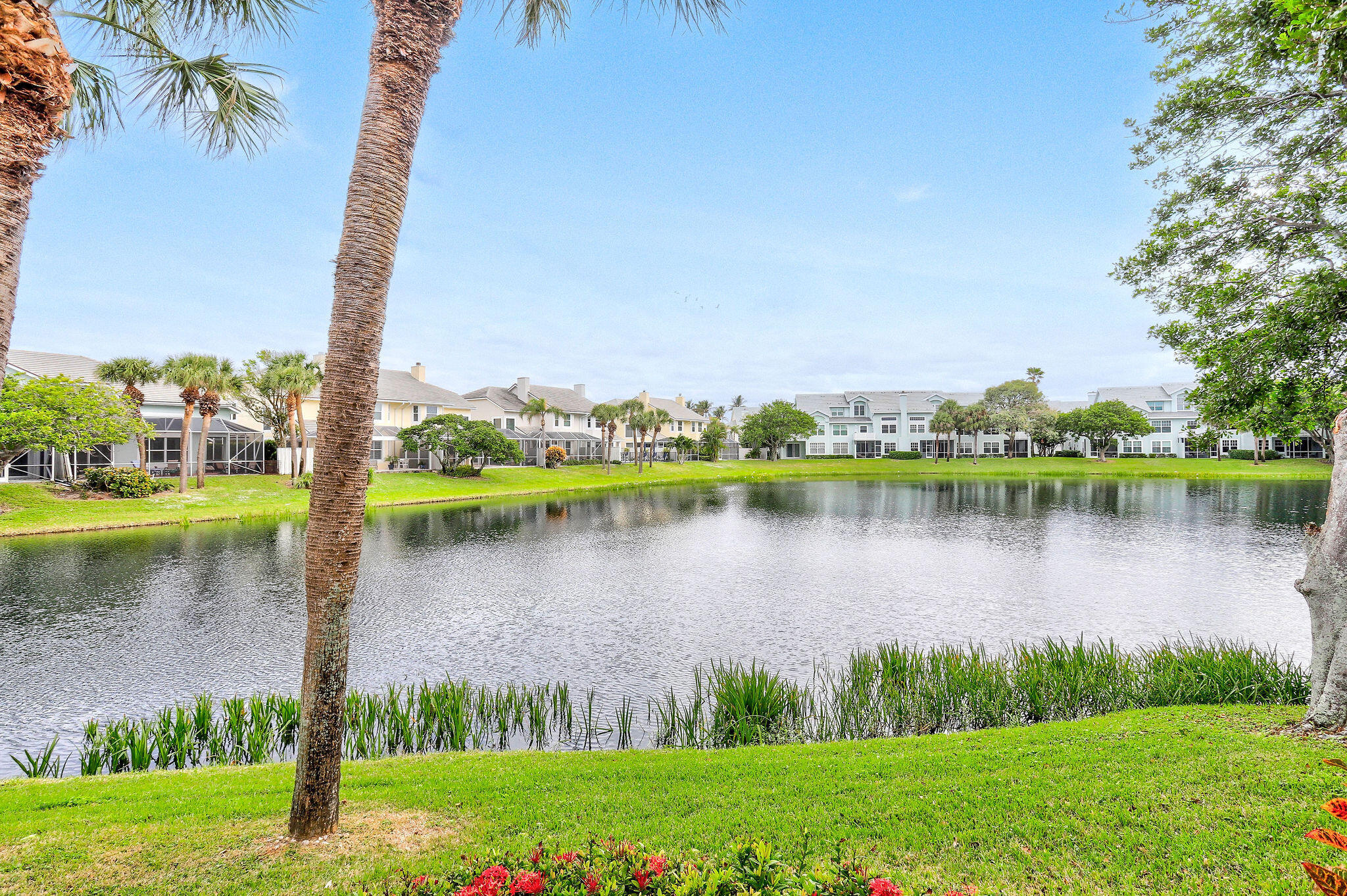 2056 Windward Way Jupiter, FL 33477 - Photo 35 of 58 a view of a lake with houses in the back