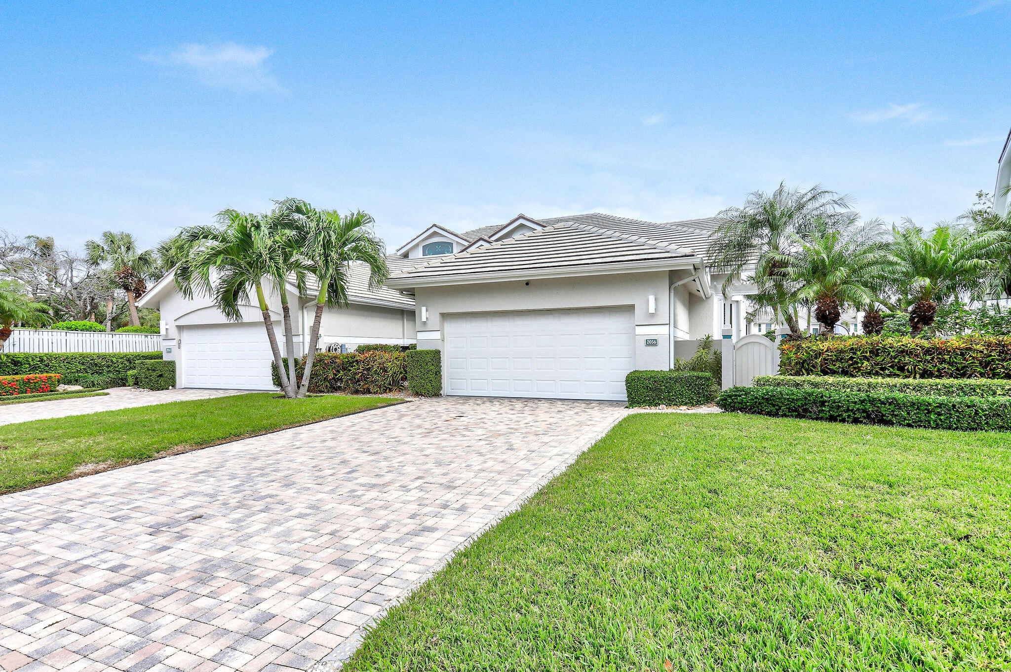 2056 Windward Way Jupiter, FL 33477 - Photo 39 of 58 a front view of a house with garden