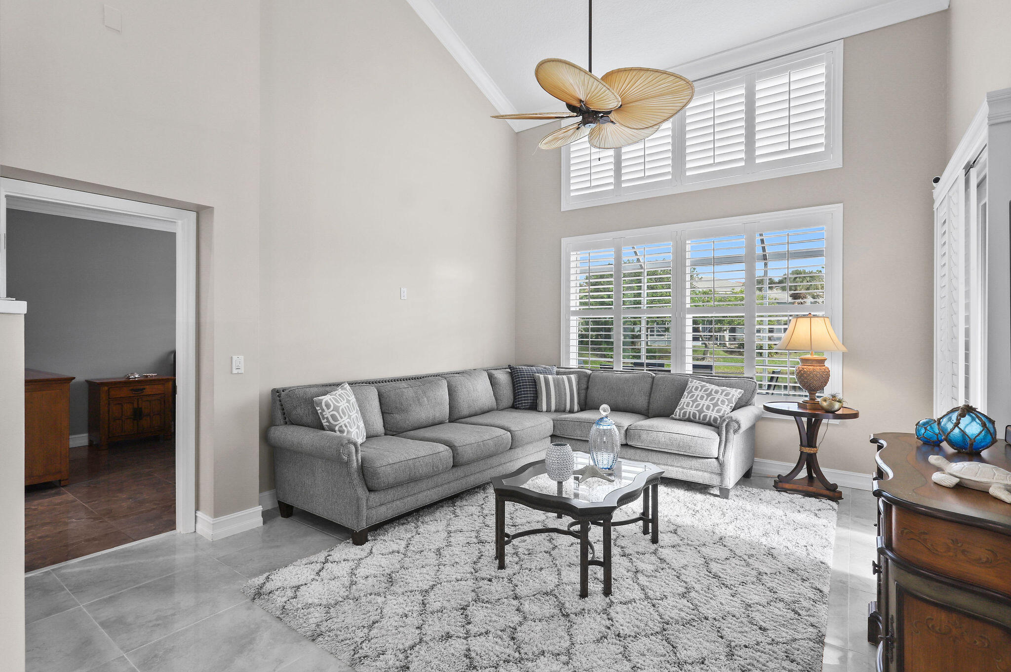 2056 Windward Way Jupiter, FL 33477 - Photo 4 of 58 a living room with furniture a chandelier and a window