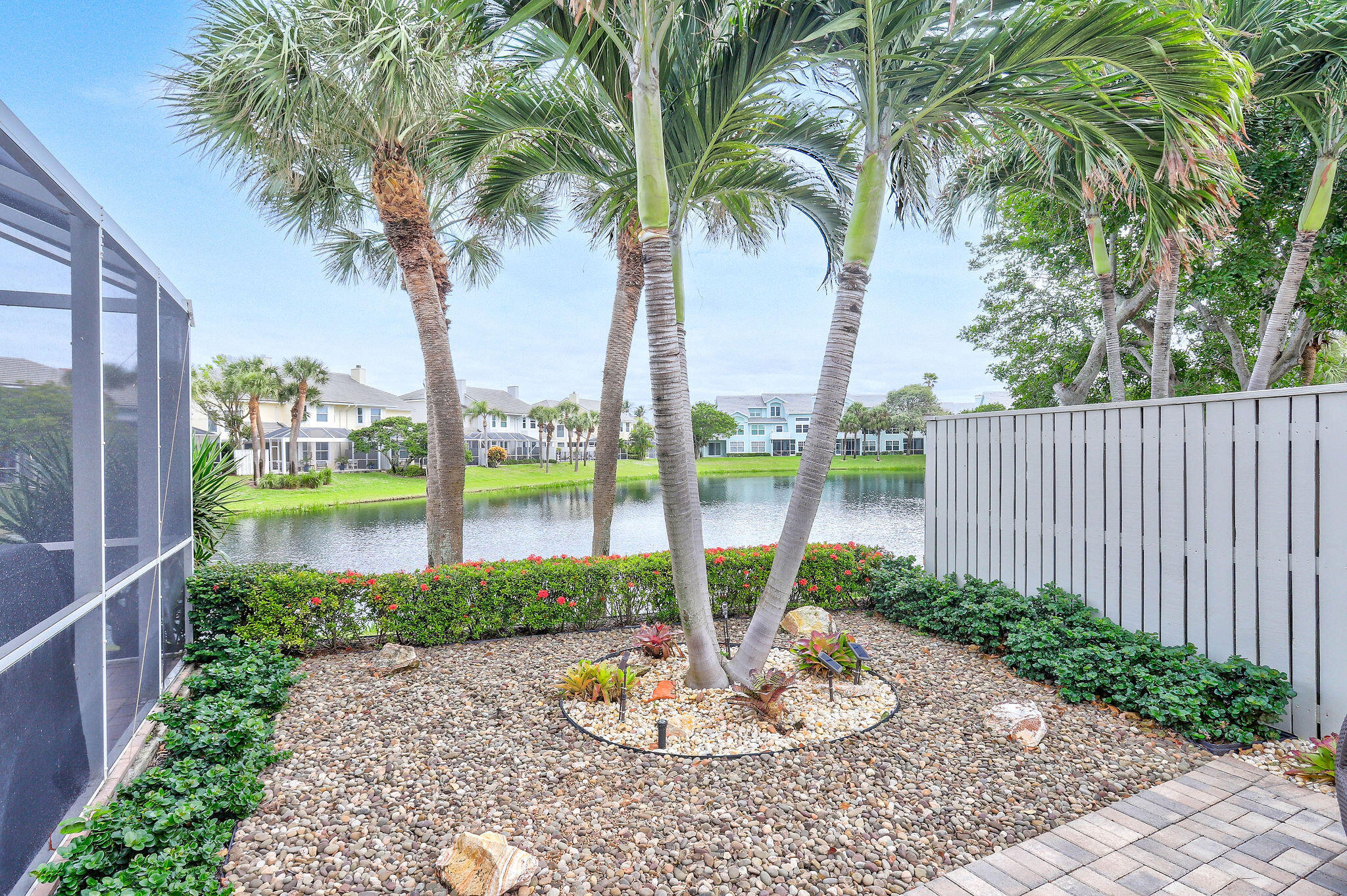 2056 Windward Way Jupiter, FL 33477 - Photo 44 of 58 a view of a swimming pool with a patio and a garden