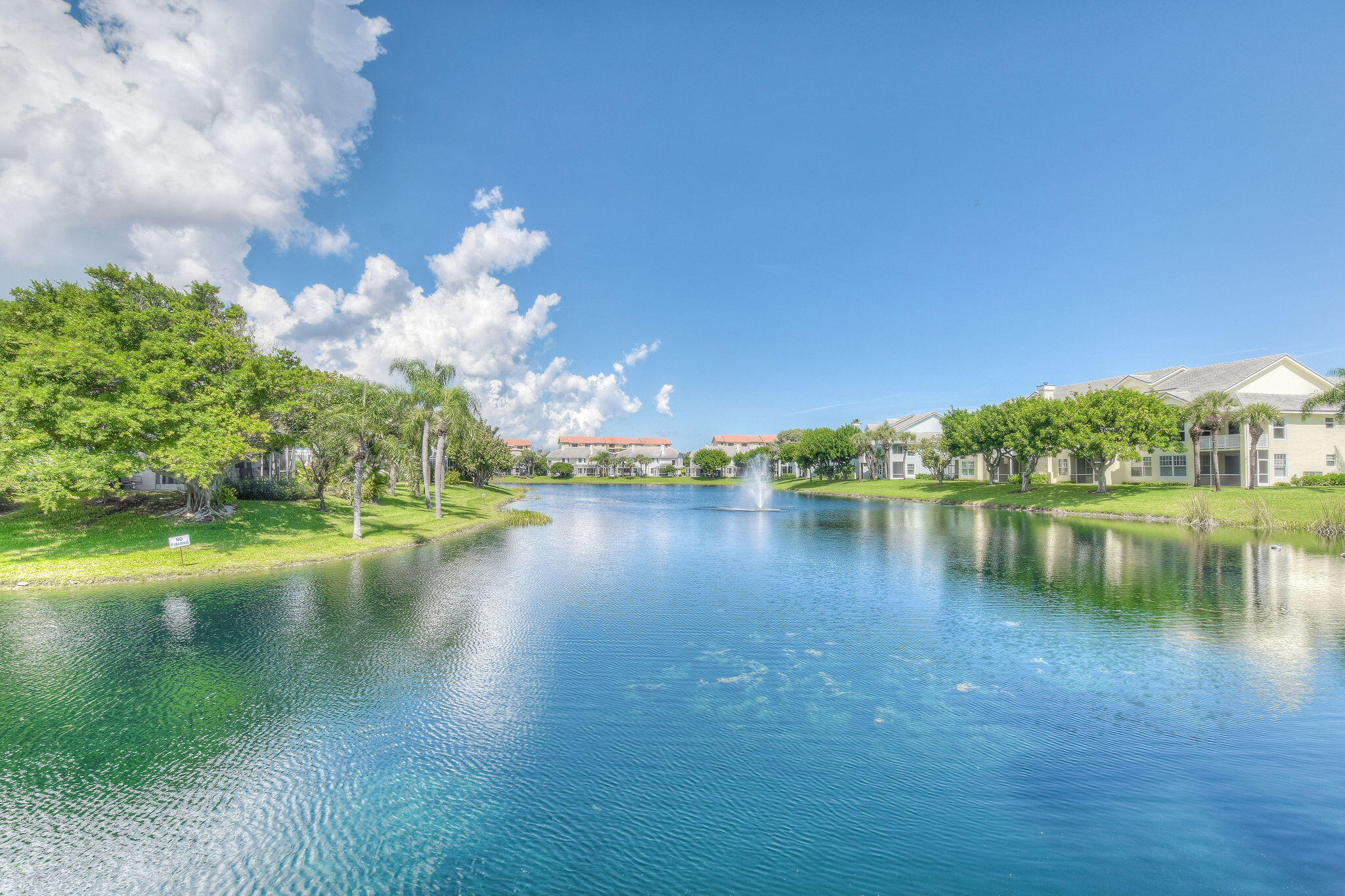 2056 Windward Way Jupiter, FL 33477 - Photo 55 of 58 a view of a lake with a yard