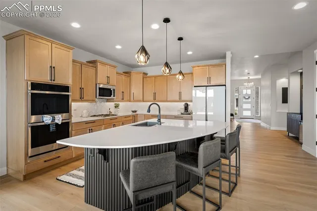 a large kitchen with a table and chairs