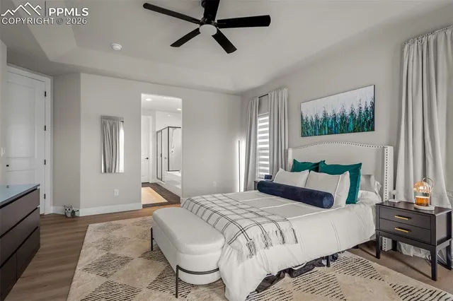 a bedroom with a bed mirror and couch