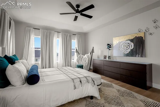 a bedroom with a bed and a large window