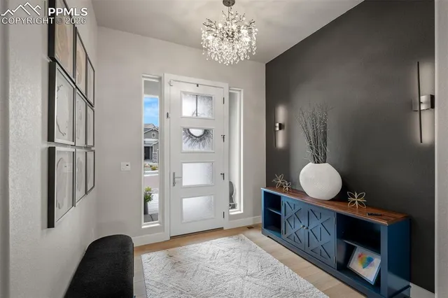 a living room with a fireplace furniture a rug and a window