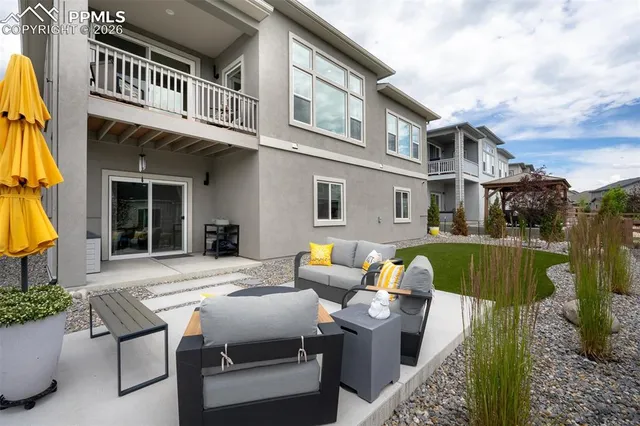 a view of a patio with couches table and chairs and potted plants