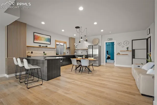 a living room with stainless steel appliances kitchen island granite countertop furniture and a kitchen view