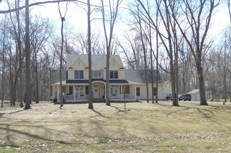 9261 Oak Ridge Drive Rochelle, IL 61068 - Photo 1 of 22 a front view of a building with trees