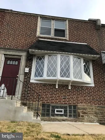 a front view of a house with parking