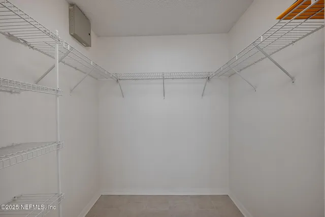 a large kitchen with a stove a sink and a microwave