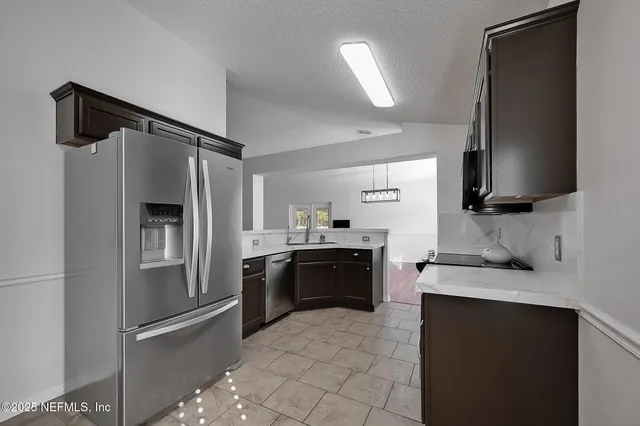 a kitchen with a sink cabinets and window