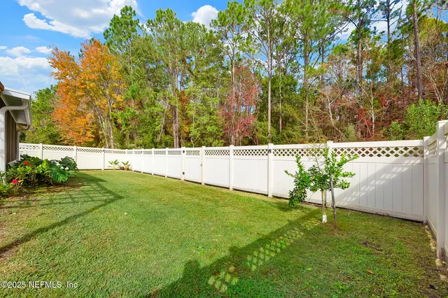 a wooden fence with trees in the background