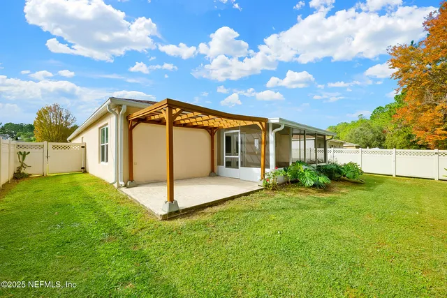 a view of a back yard of the house with a yard