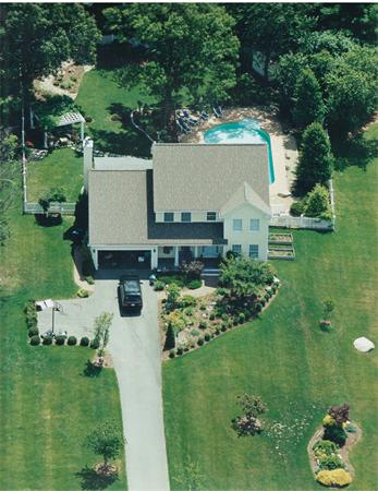 a aerial view of a house with a yard basket ball court and outdoor seating
