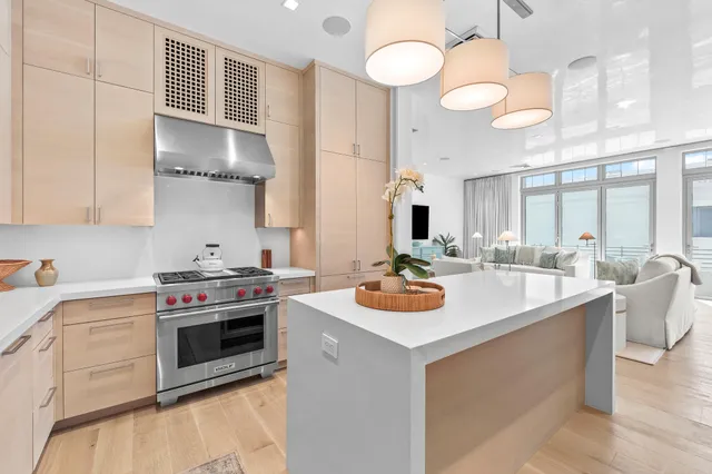 a living room with couches a flat screen tv and a large window