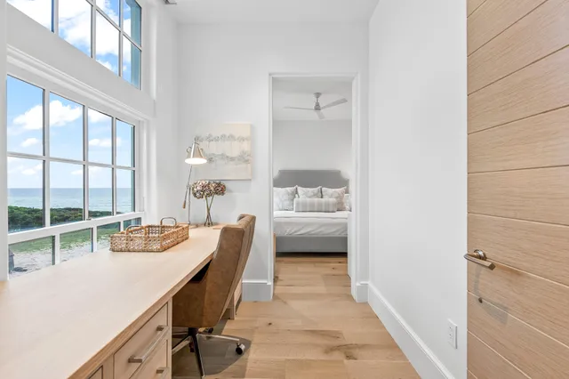 a bedroom with a large bed and a potted plant