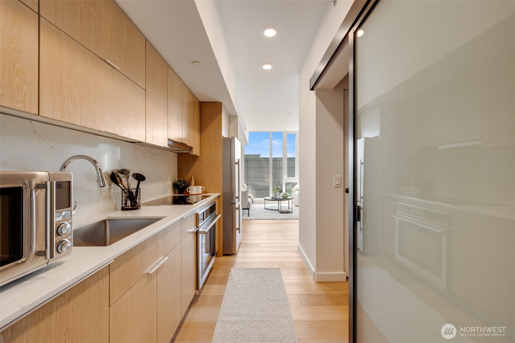 450 South Main Street, Unit 616 Seattle, WA 98104 - Photo 13 of 40 a kitchen with stainless steel appliances granite countertop lots of counter top space and wooden floor