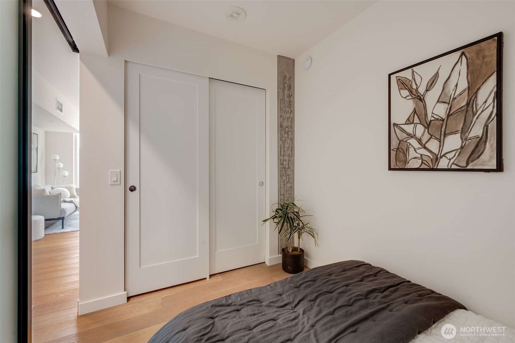 450 South Main Street, Unit 616 Seattle, WA 98104 - Photo 15 of 40 a bedroom with a bed and a painting on the wall