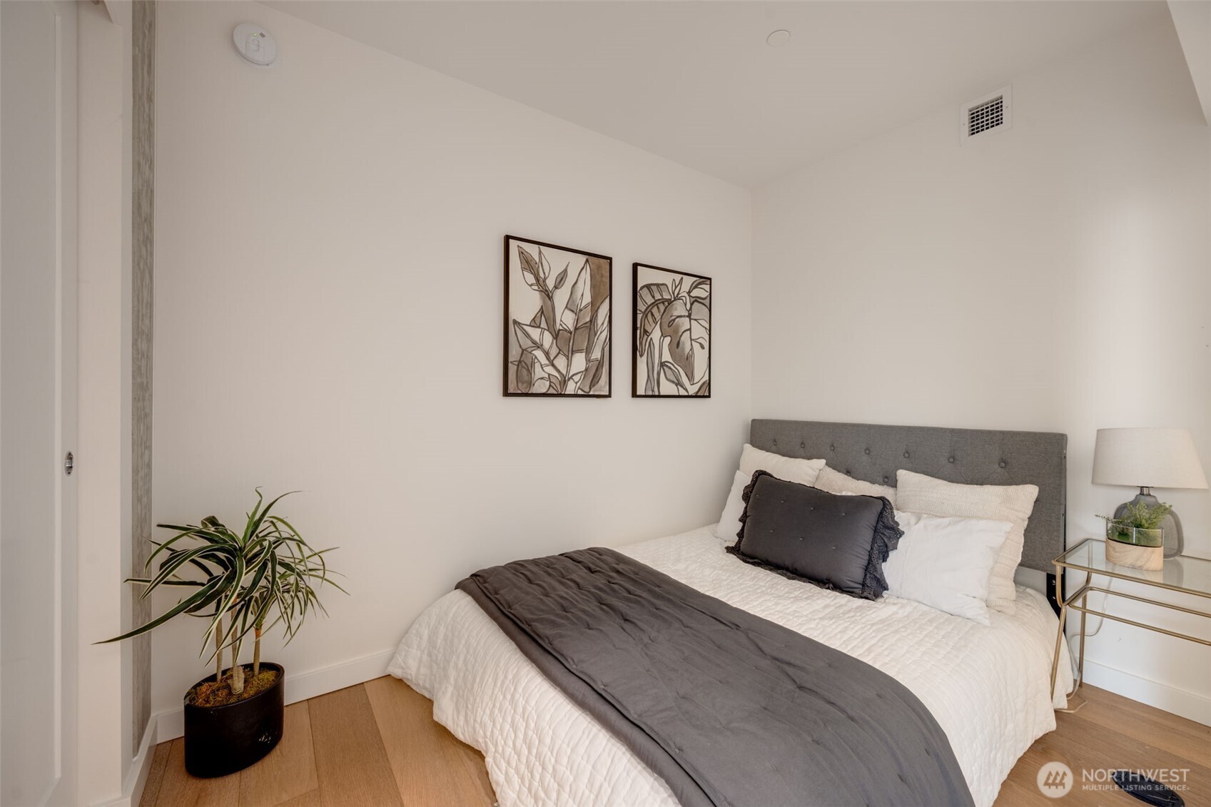 450 South Main Street, Unit 616 Seattle, WA 98104 - Photo 17 of 40 a bedroom with a bed and a potted plant