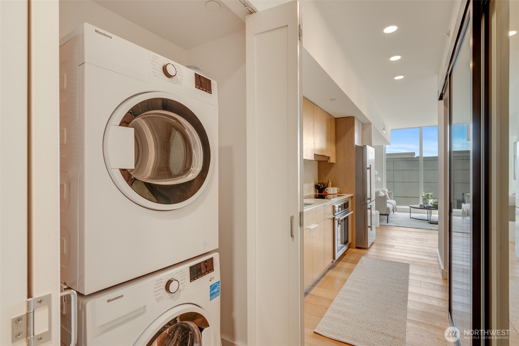 450 South Main Street, Unit 616 Seattle, WA 98104 - Photo 18 of 40 a view of a hallway with washer and dryer
