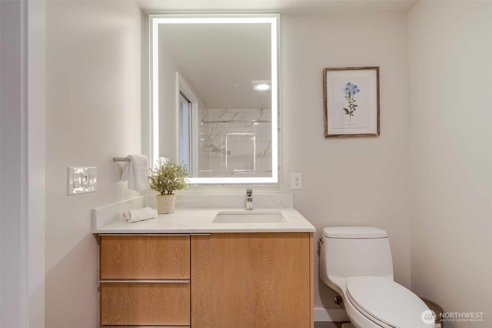 450 South Main Street, Unit 616 Seattle, WA 98104 - Photo 20 of 40 a bathroom with a sink vanity mirror and toilet