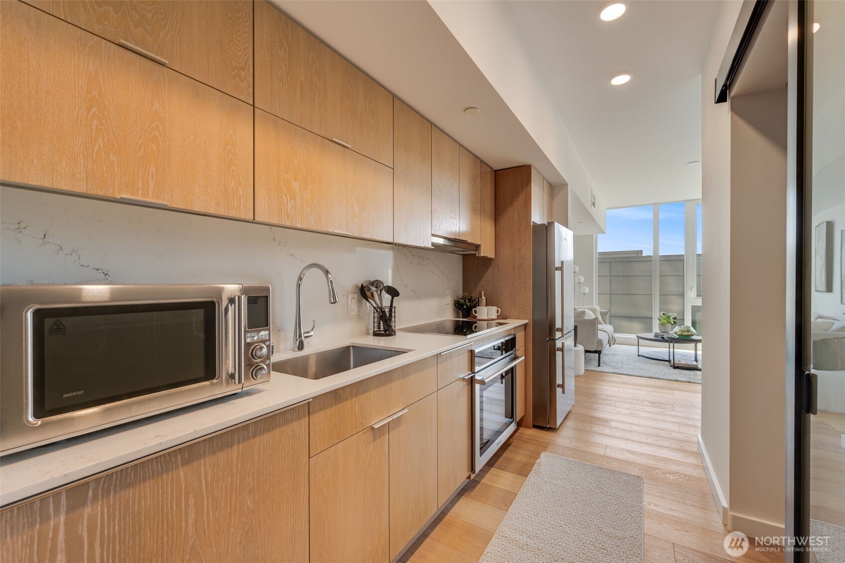 450 South Main Street, Unit 616 Seattle, WA 98104 - Photo 10 of 40 a kitchen with stainless steel appliances granite countertop a sink a stove and a refrigerator