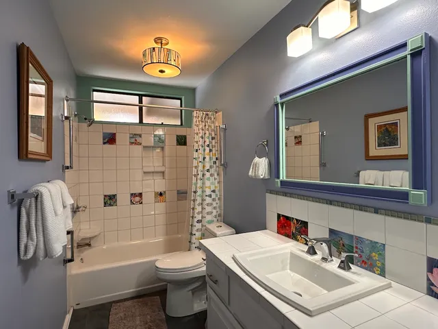 a bathroom with a sink toilet tub and shower