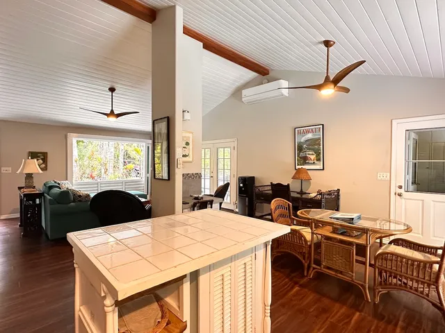a living room with furniture a window and wooden floor