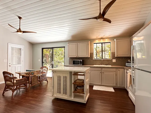 a open kitchen with stainless steel appliances granite countertop a stove cabinets and wooden floor