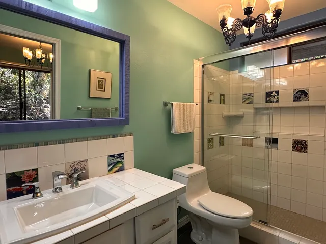 a bathroom with a sink a toilet and mirror