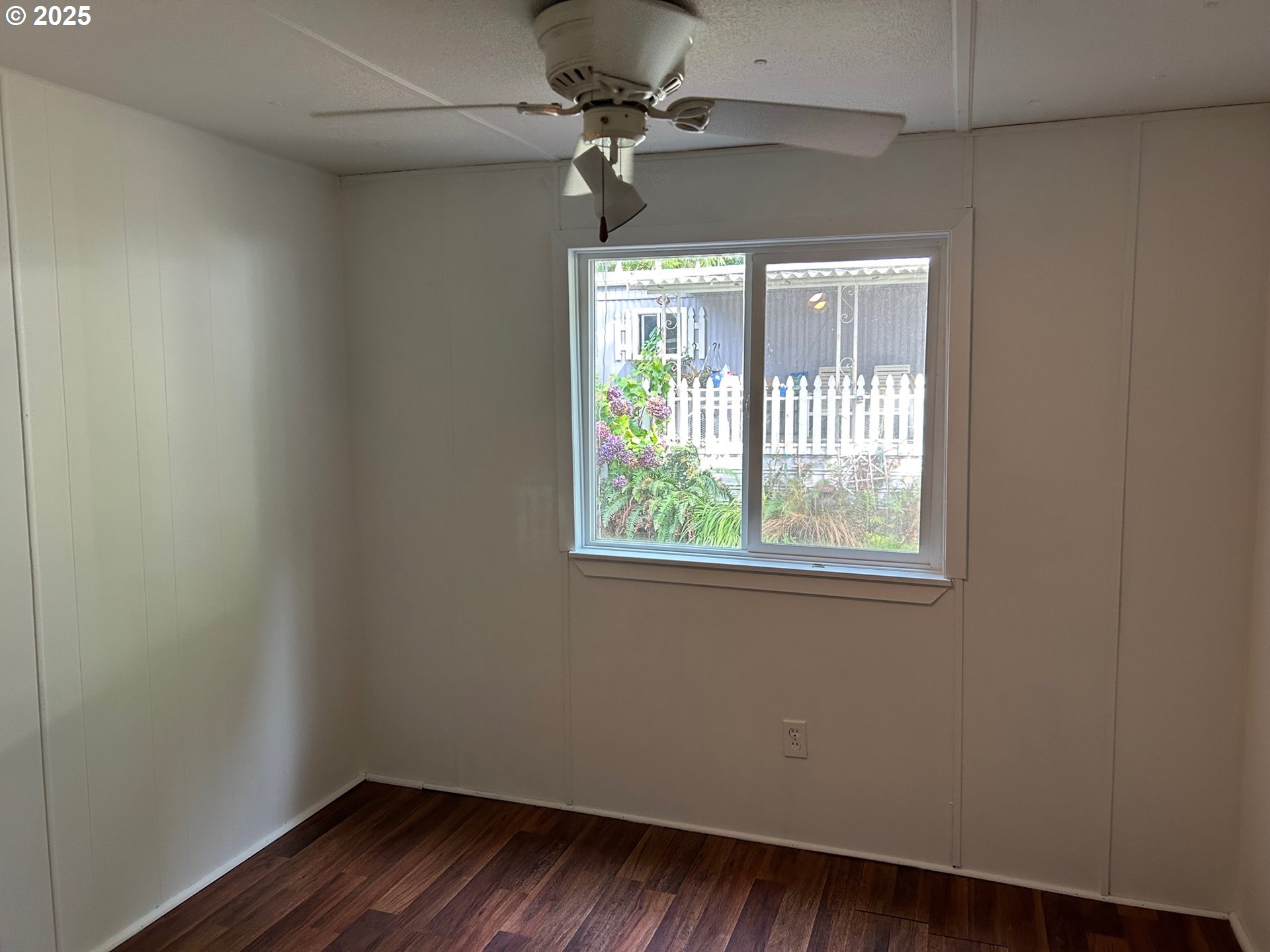 89510 Highway 101, Unit 26 Florence, OR 97439 - Photo 11 of 16 a view of a livingroom with wooden floor and a ceiling fan