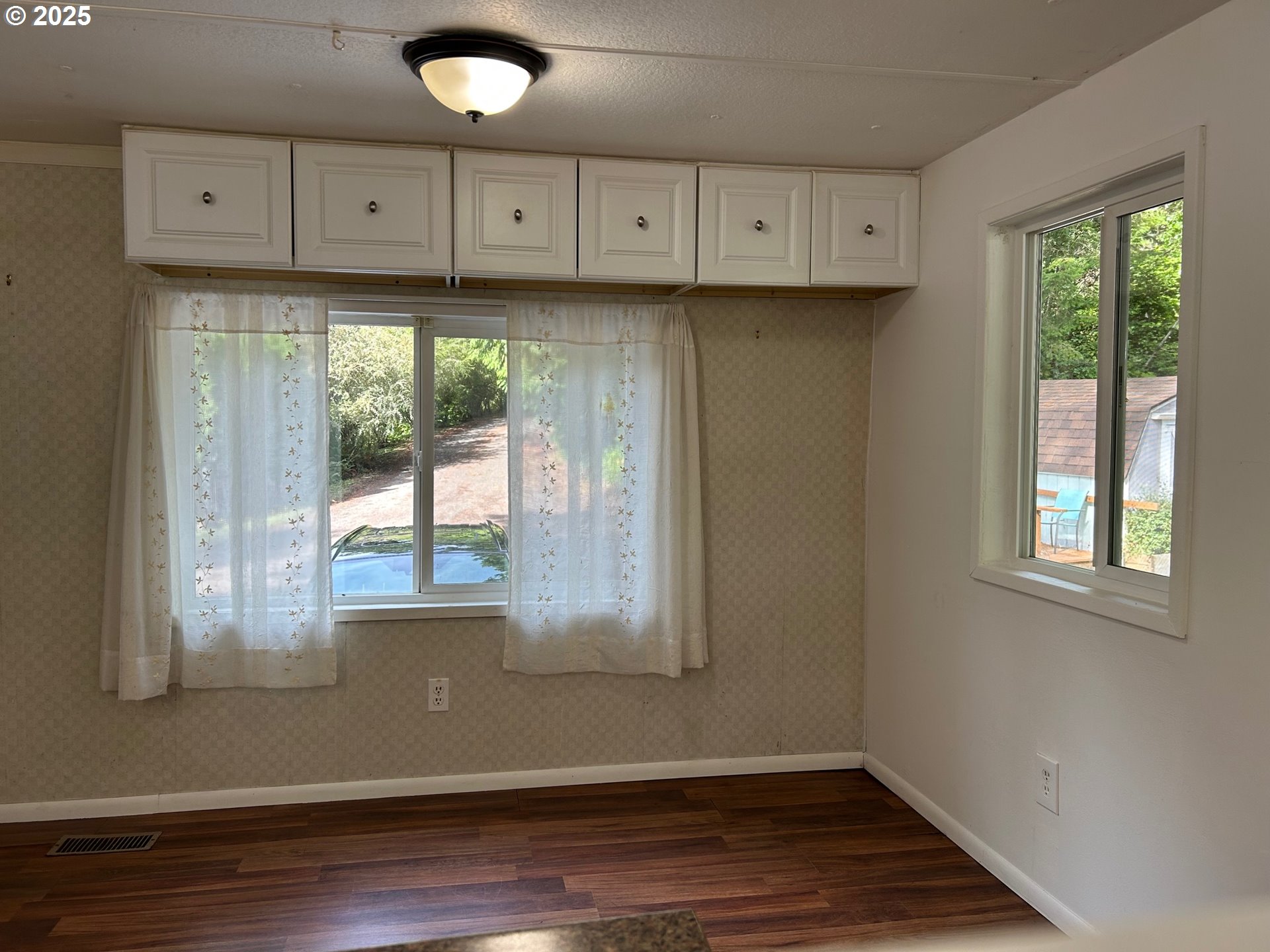 89510 Highway 101, Unit 26 Florence, OR 97439 - Photo 5 of 16 a view of kitchen with window and wooden floor