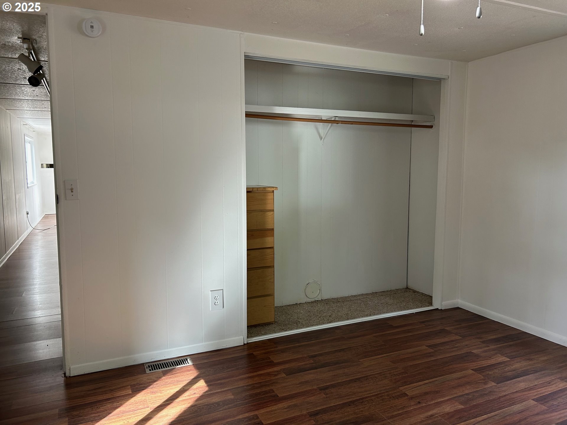 89510 Highway 101, Unit 26 Florence, OR 97439 - Photo 7 of 16 a view of an empty room with wooden floor