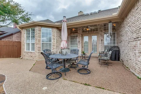 a view of a patio with table and chairs and potted plants