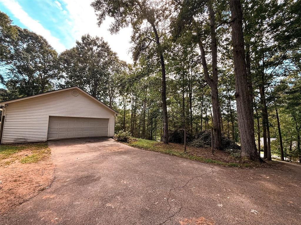 334 Summit Heights Drive Nicholson, GA 30565 - Photo 21 of 25 a backyard of a house with large trees and plants