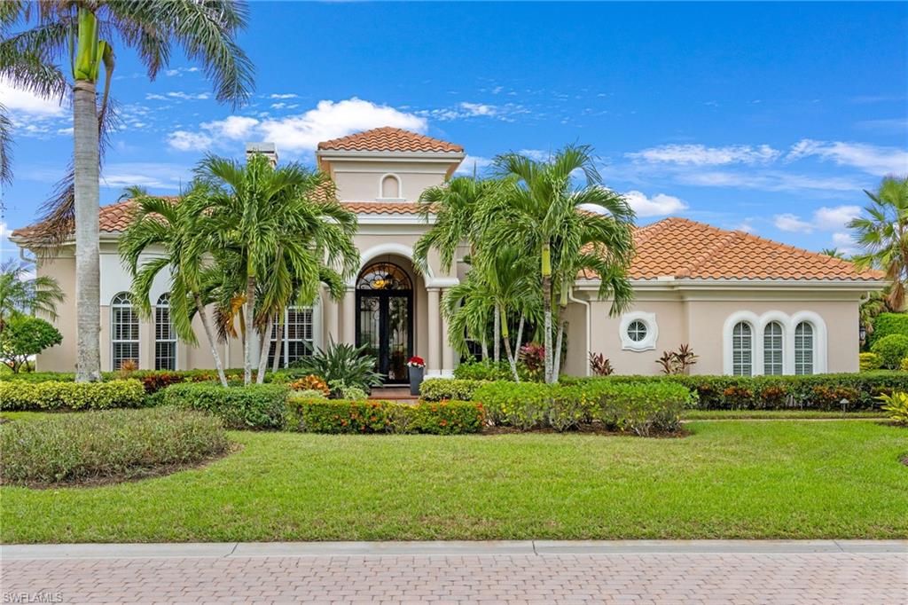 7511 Hogan Court Naples, FL 34113 - Photo 1 of 50 a front view of a house with a garden