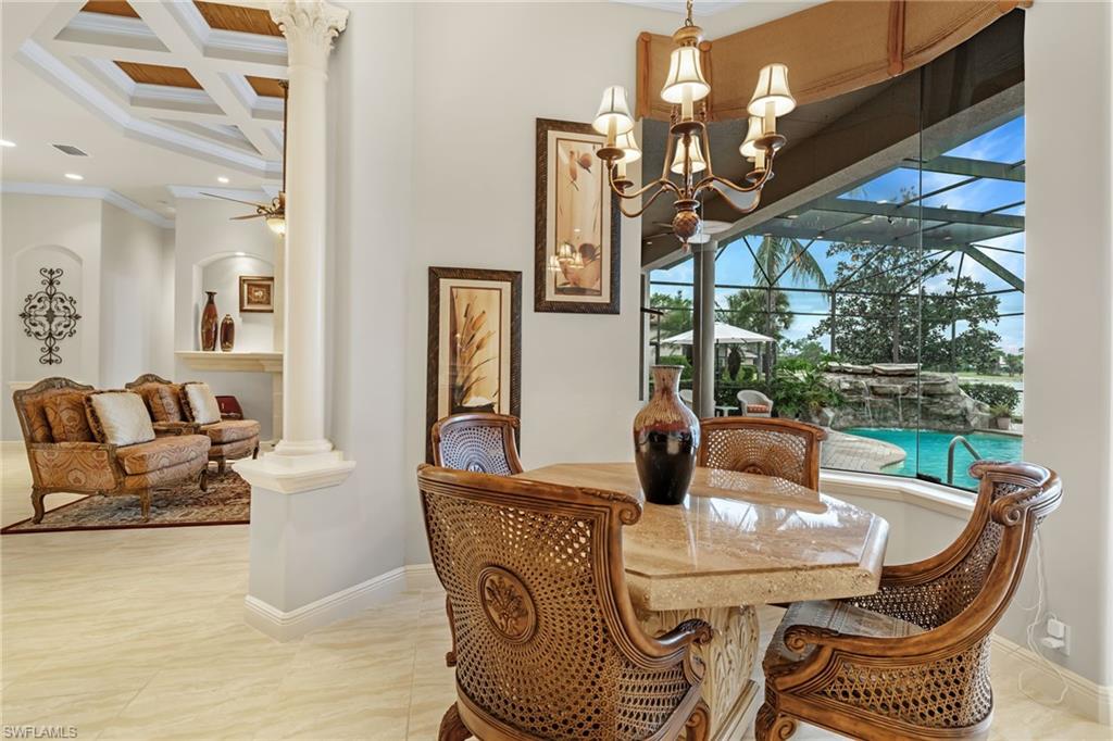 7511 Hogan Court Naples, FL 34113 - Photo 13 of 50 a view of a dining room with furniture wooden floor a chandelier