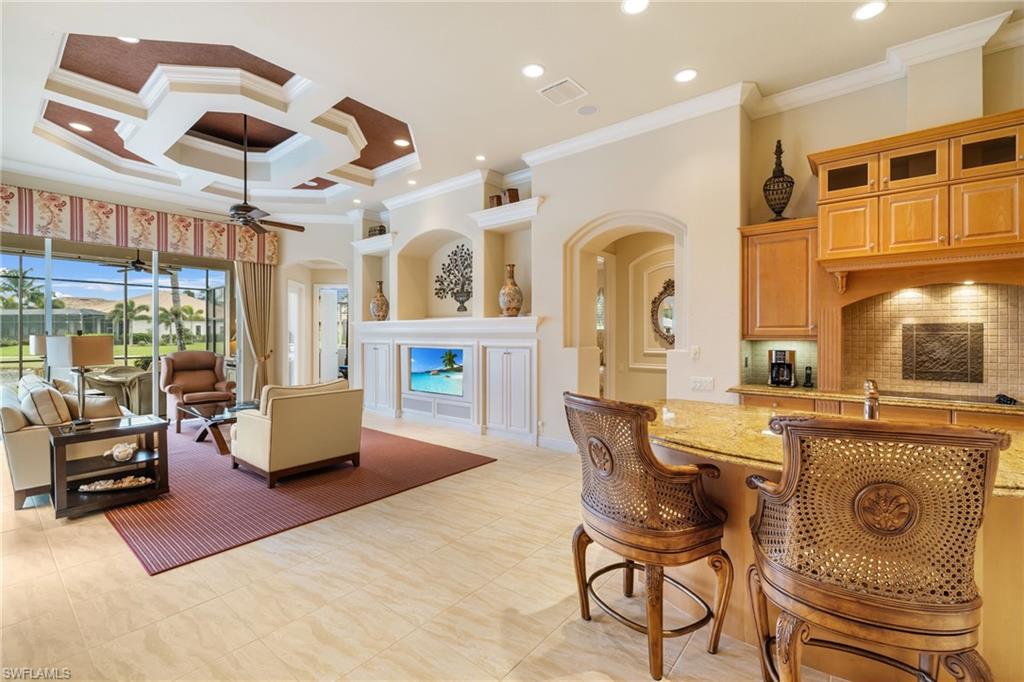7511 Hogan Court Naples, FL 34113 - Photo 15 of 50 a living room with fireplace furniture and a large window