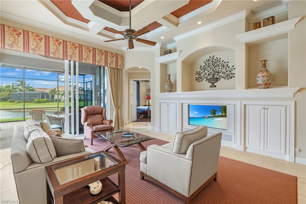 7511 Hogan Court Naples, FL 34113 - Photo 16 of 50 a living room with furniture a ceiling fan and a window