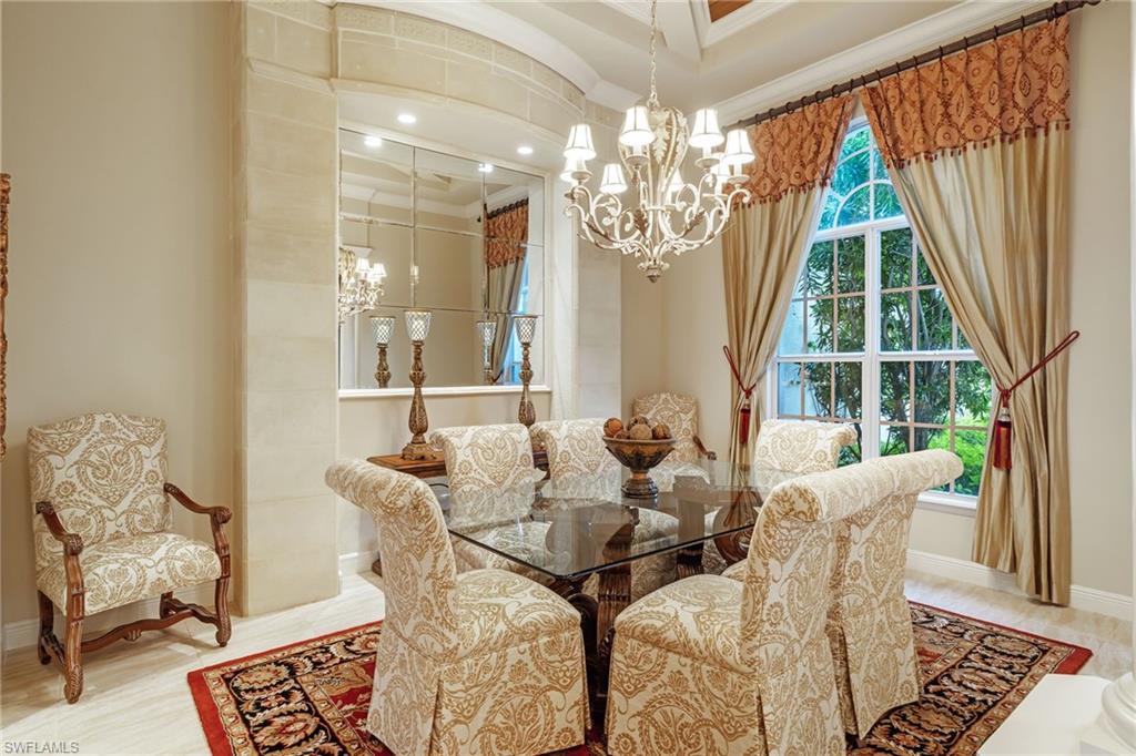 7511 Hogan Court Naples, FL 34113 - Photo 18 of 50 a living room with furniture and a chandelier