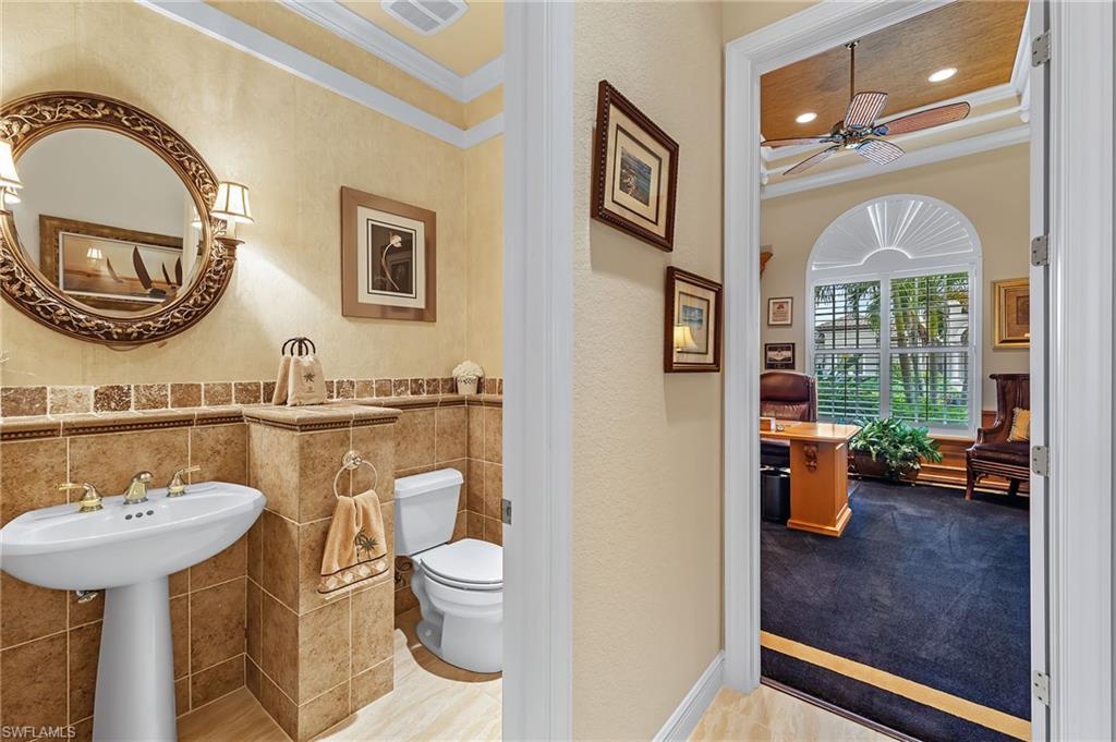 7511 Hogan Court Naples, FL 34113 - Photo 20 of 50 a bathroom with a toilet a sink and a mirror