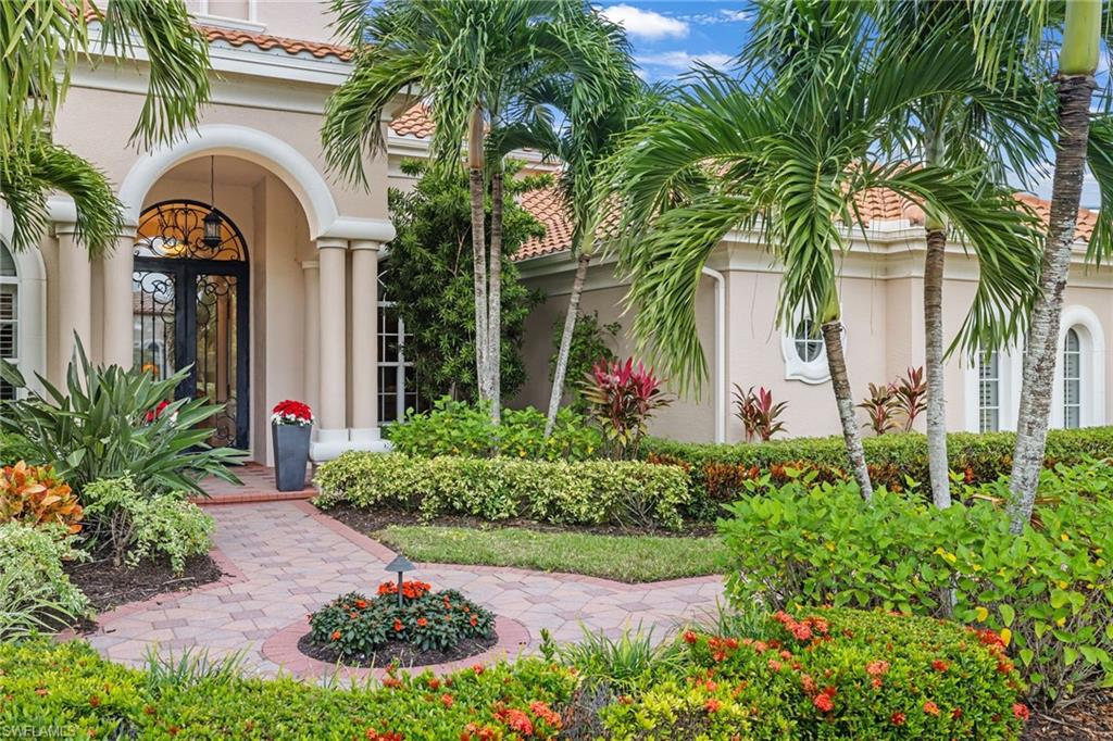 7511 Hogan Court Naples, FL 34113 - Photo 2 of 50 a front view of yellow and flowers