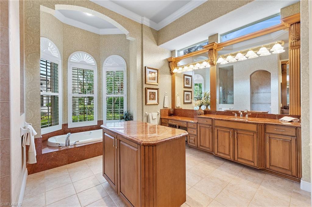 7511 Hogan Court Naples, FL 34113 - Photo 26 of 50 a spacious en suite bathroom with sink mirror and large window